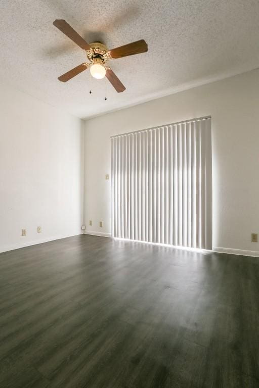 unfurnished room with a textured ceiling, dark hardwood / wood-style floors, and ceiling fan