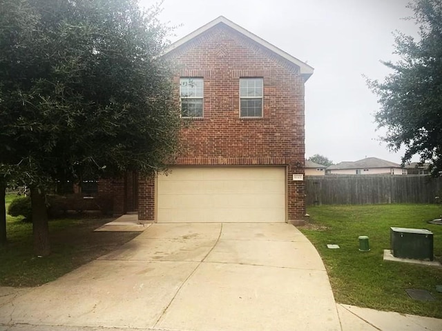 view of front of property featuring a garage and a front yard