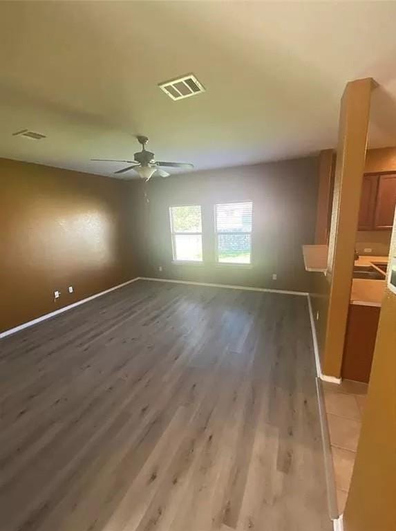 empty room with ceiling fan and wood-type flooring