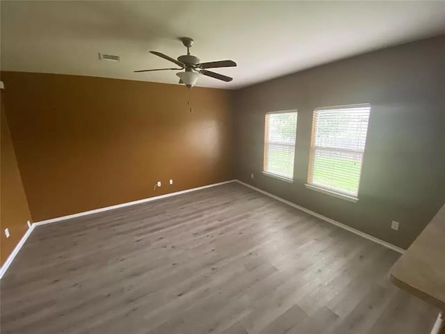 empty room featuring ceiling fan and wood-type flooring