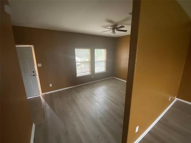 spare room featuring hardwood / wood-style flooring and ceiling fan