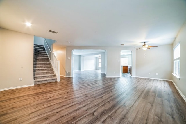 unfurnished living room featuring ceiling fan and hardwood / wood-style floors