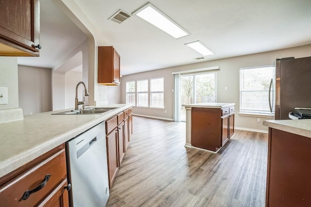 kitchen featuring sink, appliances with stainless steel finishes, and light hardwood / wood-style flooring