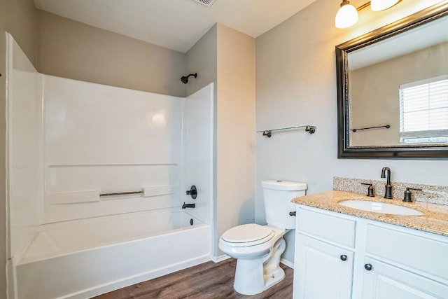 full bathroom featuring vanity, toilet, wood-type flooring, and bathing tub / shower combination