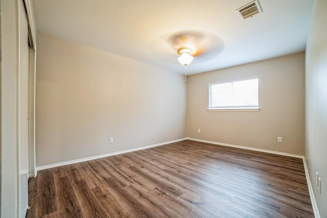 unfurnished bedroom with a closet, dark hardwood / wood-style floors, and ceiling fan