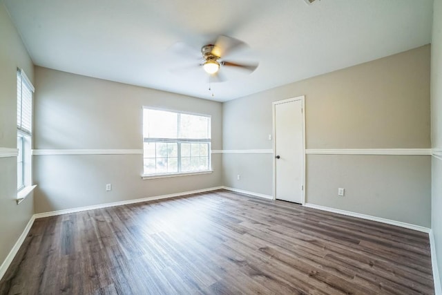 spare room featuring ceiling fan and dark wood-type flooring