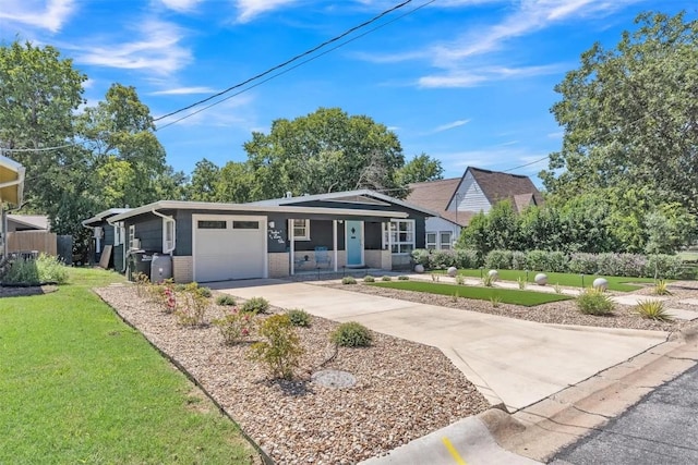 single story home with a front yard, a porch, and a garage