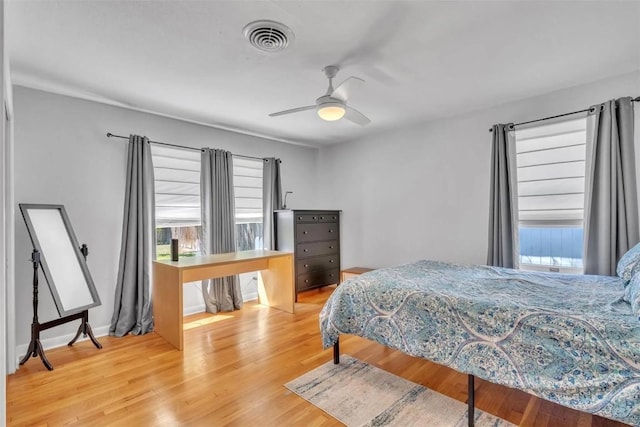 bedroom with ceiling fan and wood-type flooring