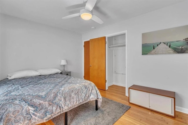 bedroom featuring hardwood / wood-style floors, ceiling fan, and a closet