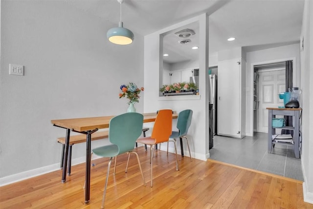 dining space with wood-type flooring