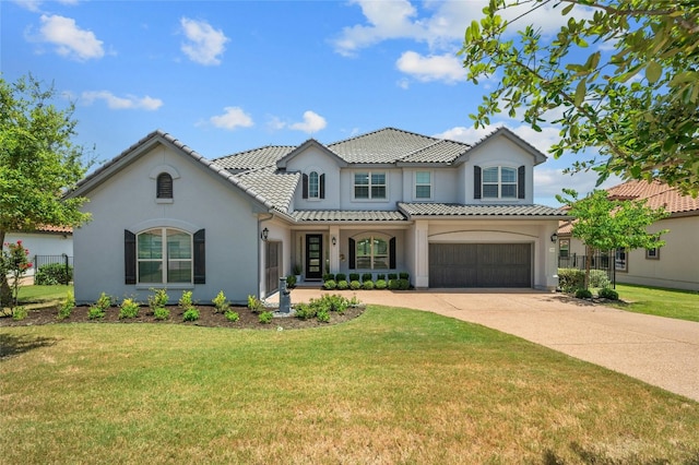 mediterranean / spanish home with a front yard and a garage