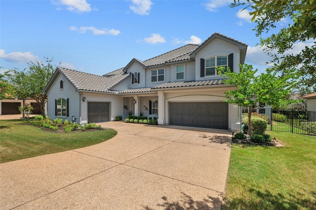 mediterranean / spanish-style house with a front lawn and a garage