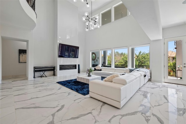 living room with a notable chandelier and a high ceiling