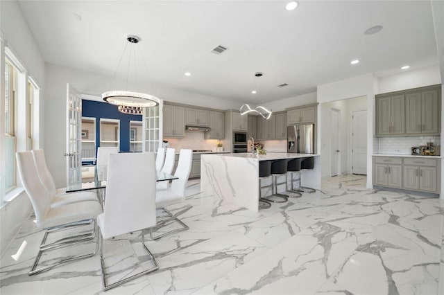 dining space with an inviting chandelier and sink