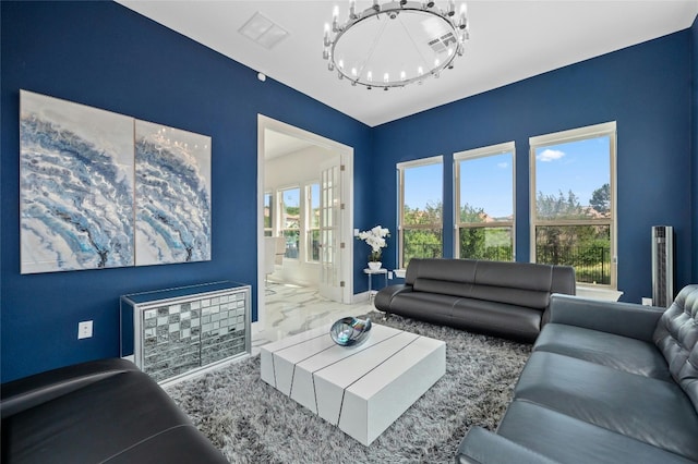 living room with a wealth of natural light and an inviting chandelier