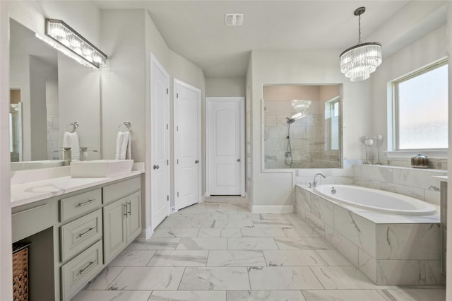 bathroom with shower with separate bathtub, vanity, and an inviting chandelier