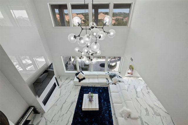 living room featuring a high ceiling and an inviting chandelier