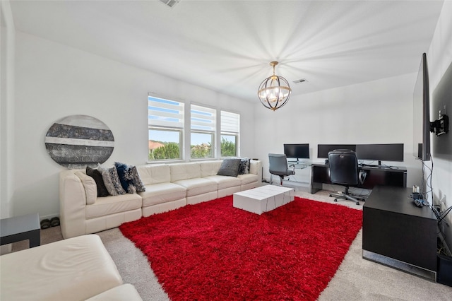 carpeted living room with a notable chandelier