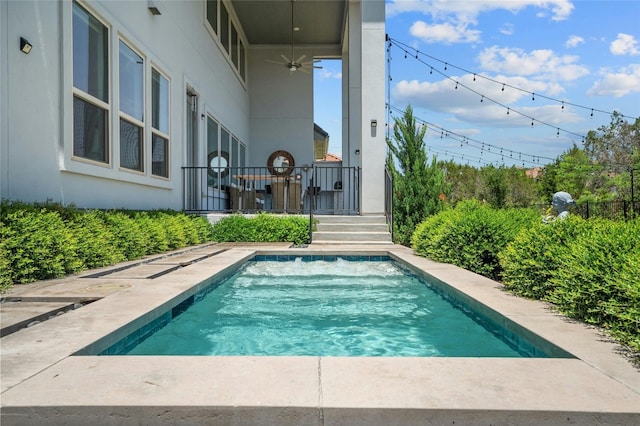 view of swimming pool featuring ceiling fan