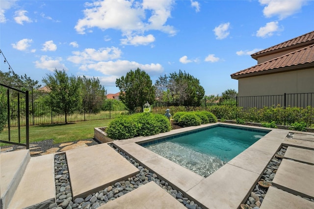 view of swimming pool with a yard