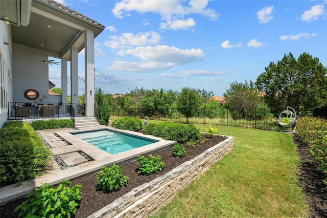 view of swimming pool with a yard