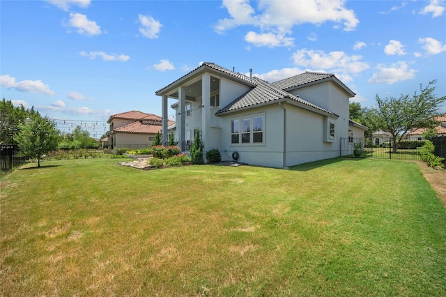 back of property featuring a lawn