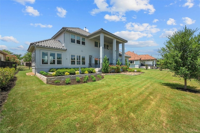 rear view of house with a yard