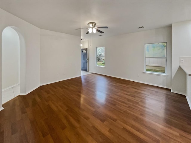 spare room with ceiling fan and dark hardwood / wood-style flooring