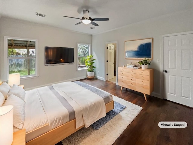 bedroom with dark hardwood / wood-style flooring, multiple windows, crown molding, and ceiling fan