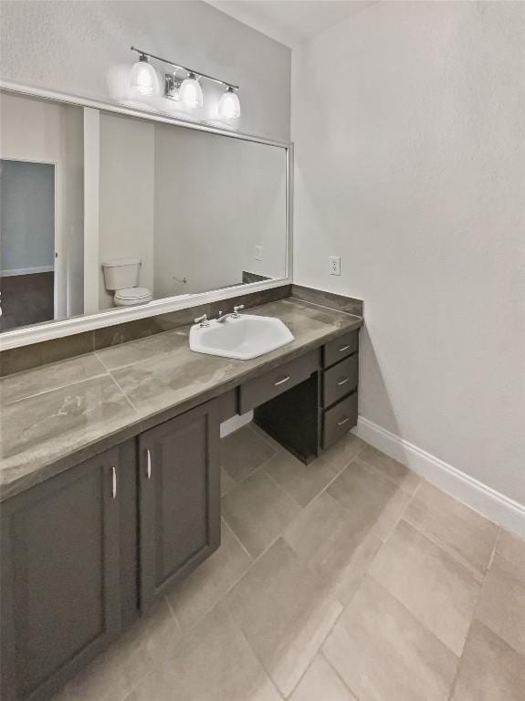 bathroom featuring tile patterned floors, vanity, and toilet