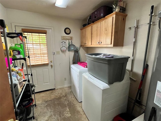 clothes washing area with cabinets and independent washer and dryer