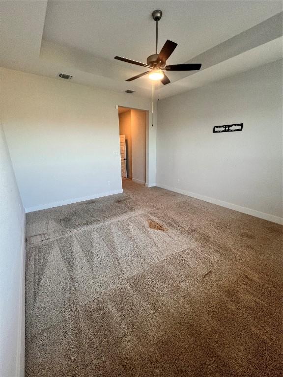 unfurnished room featuring carpet and ceiling fan