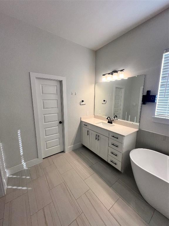 bathroom featuring a bathing tub and vanity