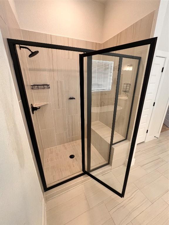 bathroom featuring a shower with door