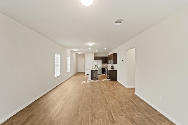 unfurnished living room featuring light hardwood / wood-style floors