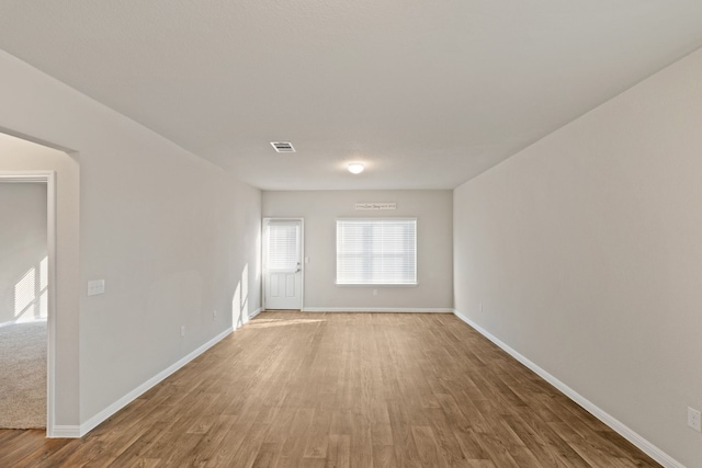 unfurnished room with hardwood / wood-style flooring