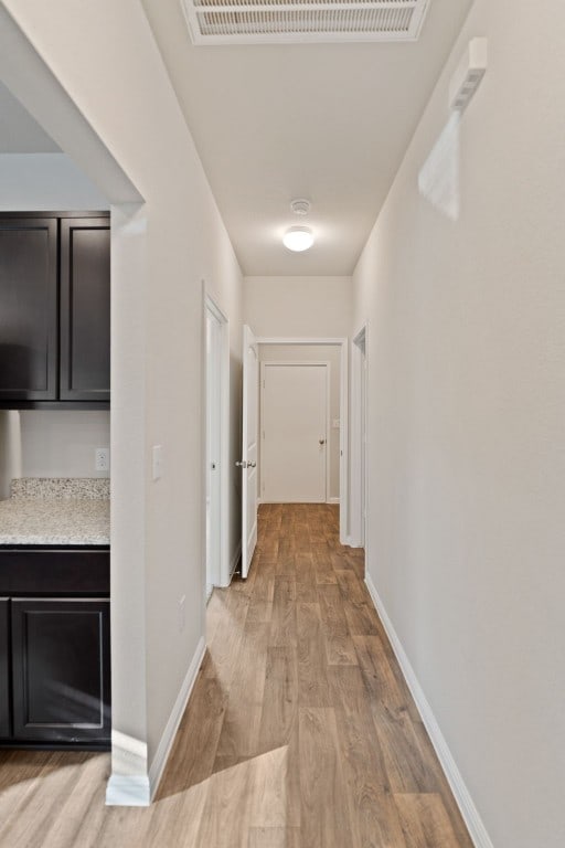 hallway with light hardwood / wood-style flooring