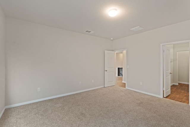 unfurnished bedroom featuring light carpet