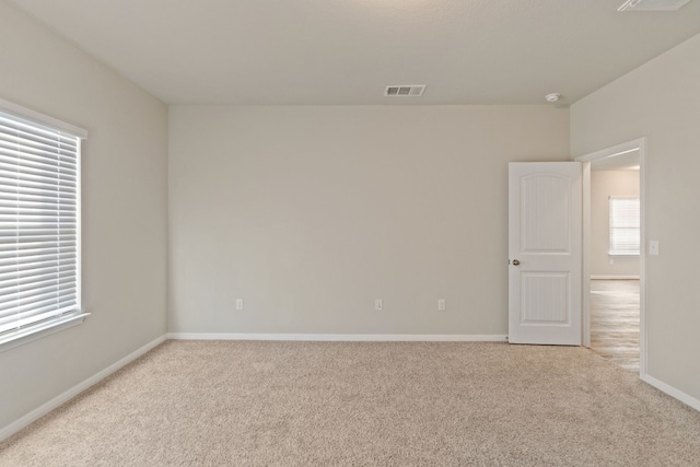 spare room with light carpet