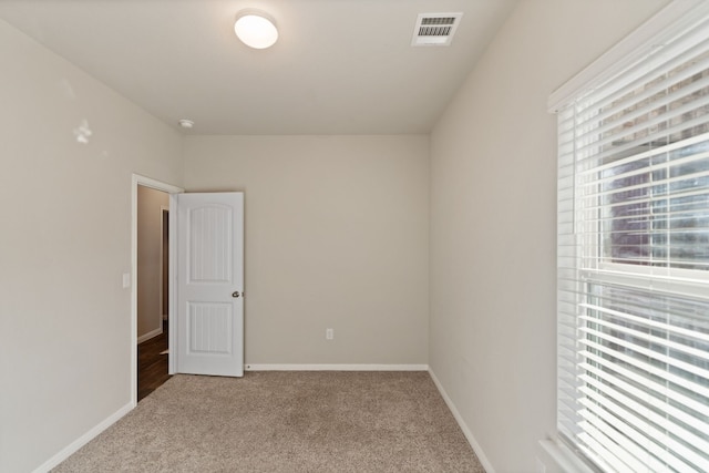 unfurnished room with light carpet