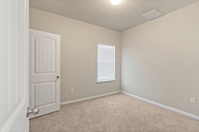 empty room featuring light carpet