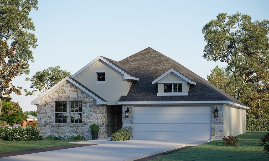 view of front of property with a garage and a front yard