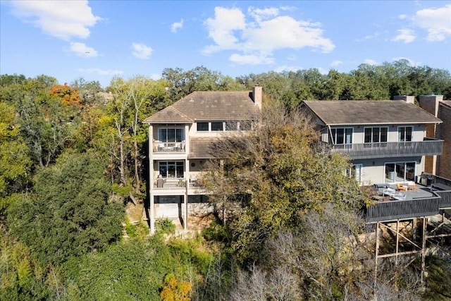 rear view of property featuring a balcony