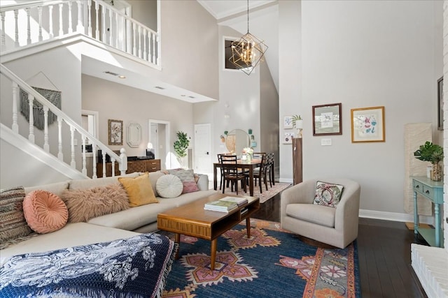 living room featuring a notable chandelier, a high ceiling, and hardwood / wood-style flooring