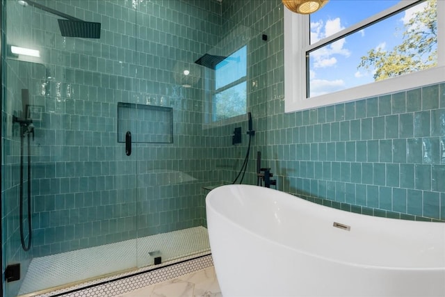 bathroom featuring shower with separate bathtub