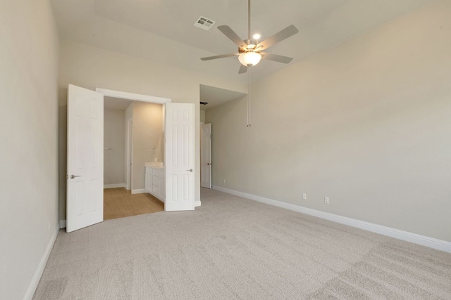 2921 Zuni Path, Leander, TX 78641 - unfurnished bedroom with light carpet, a ceiling fan, and ensuite bath