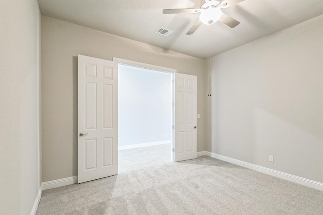 carpeted empty room featuring visible vents, baseboards, and a ceiling fan