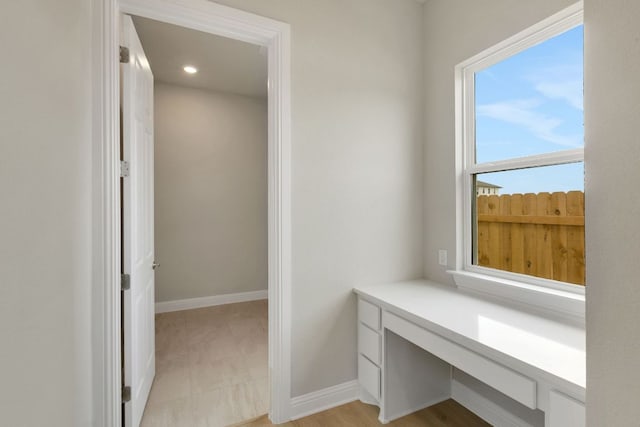 unfurnished office with baseboards and recessed lighting