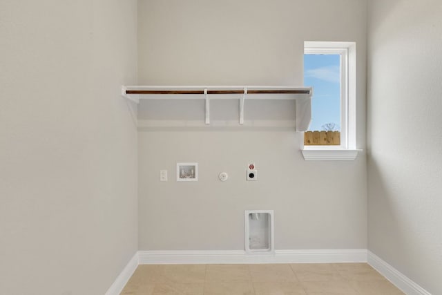 laundry area with baseboards, electric dryer hookup, gas dryer hookup, laundry area, and hookup for a washing machine