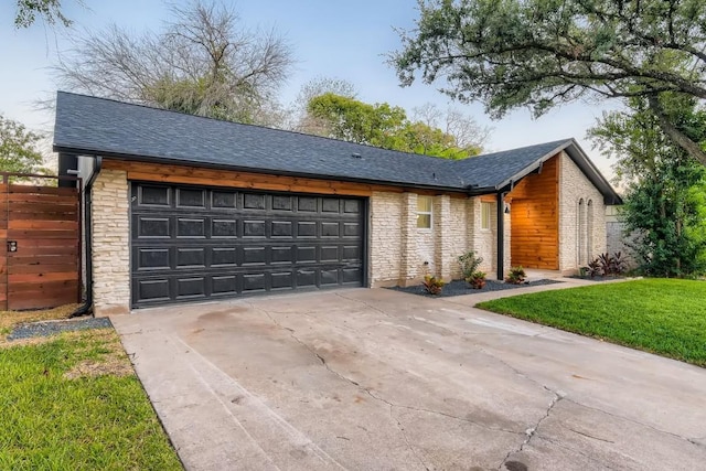 view of front of property with a garage and a front lawn